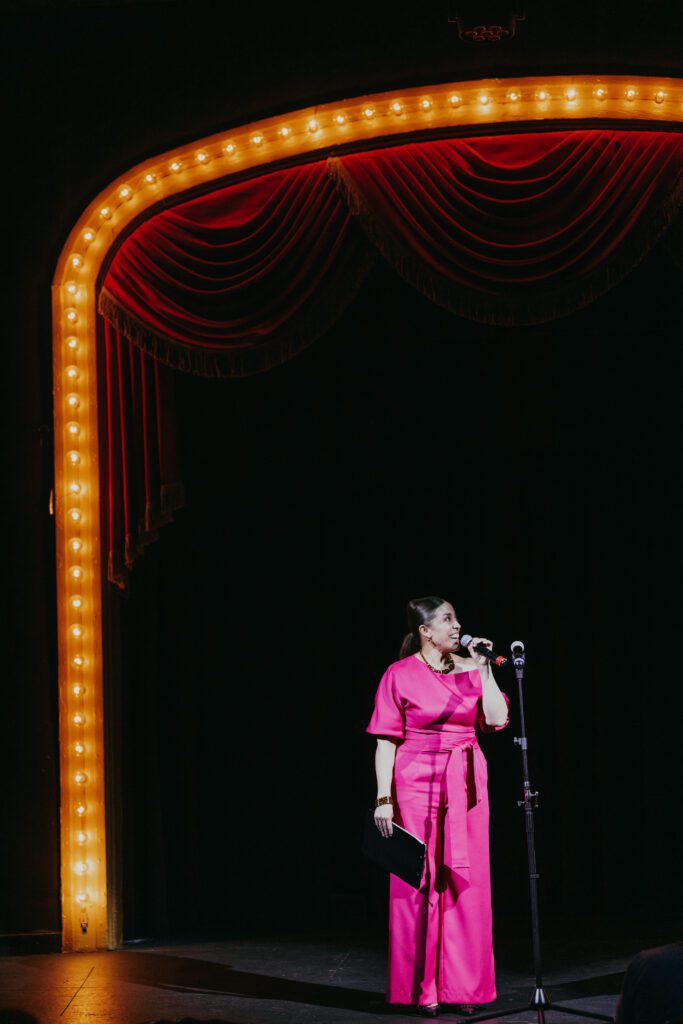 Picture of Christina Walker on a stage wearing a pink dress
